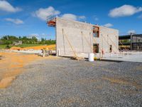 the cement structure on the construction site is under construction in the daytime or afternoon sky