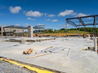 large concrete slab on top of ground in construction site under construction cranes and building materials