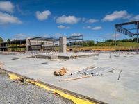 large concrete slab on top of ground in construction site under construction cranes and building materials