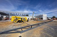 a construction site with crane and a steel structure in the background and a sky background