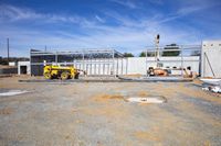 a construction site with people standing at the edge of it and looking over the concrete