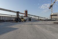 a construction site with several machines sitting in the middle of it and other items around