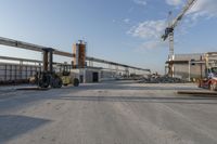 a construction site with several machines sitting in the middle of it and other items around