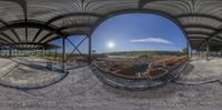 the large fish eye lens is used on this photo of a construction site with a hillside and ocean