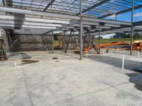 a construction site with many workers working and machinery parked on the ground in it's storage rack