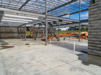 a construction site with many workers working and machinery parked on the ground in it's storage rack