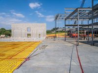 a large open room and construction area with yellow tape around it that has concrete and steel fencing