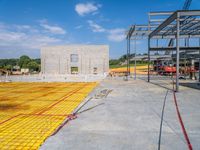 a large open room and construction area with yellow tape around it that has concrete and steel fencing