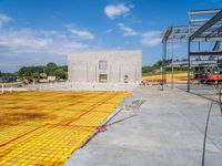 a large open room and construction area with yellow tape around it that has concrete and steel fencing