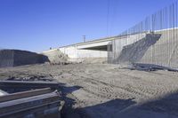 construction work at the corner of an underpass under a highway bridge in the desert
