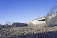 construction work at the corner of an underpass under a highway bridge in the desert