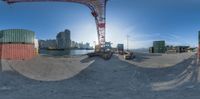 a man is using a fish eye lens to see a container being loaded onto the ship