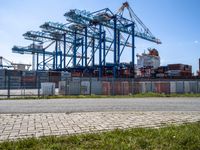 container ships are at a dock on a sunny day in the water's edge