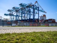 container ships are at a dock on a sunny day in the water's edge