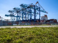 container ships are at a dock on a sunny day in the water's edge