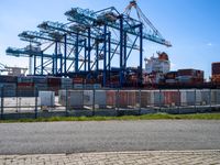 container ships are at a dock on a sunny day in the water's edge