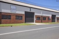 a building with several doors that open to let in more light from the road, and an arrow sign that reads 5