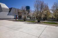 the concrete is white and has some flowers on it in front of the building and outside