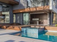 a kitchen is sitting in the pool and covered with wood walls, overlooking the courtyard