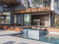 a kitchen is sitting in the pool and covered with wood walls, overlooking the courtyard