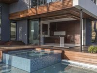 a kitchen is sitting in the pool and covered with wood walls, overlooking the courtyard