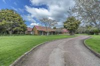 this country style house features an expansive lawn area that leads to the garages and rear yard