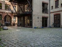 a courtyard in a building with a bicycle parked near it and other buildings around it