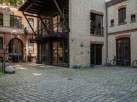 a courtyard in a building with a bicycle parked near it and other buildings around it