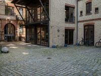 a courtyard in a building with a bicycle parked near it and other buildings around it