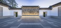 the interior courtyard with a fountain, and wall decorated with a medallion of a dragon