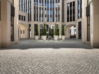 a courtyard in a building with pots on either side of it that are sitting beside each other