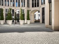 a courtyard in a building with pots on either side of it that are sitting beside each other