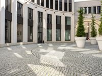 a courtyard in a building with pots on either side of it that are sitting beside each other