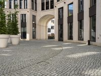 a courtyard in a building with pots on either side of it that are sitting beside each other