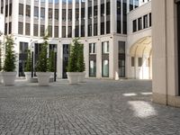 a courtyard in a building with pots on either side of it that are sitting beside each other