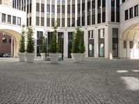 a courtyard in a building with pots on either side of it that are sitting beside each other