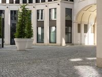 a courtyard in a building with pots on either side of it that are sitting beside each other