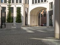 a courtyard in a building with pots on either side of it that are sitting beside each other