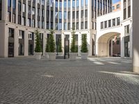 a courtyard in a building with pots on either side of it that are sitting beside each other