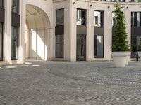 a courtyard in a building with pots on either side of it that are sitting beside each other