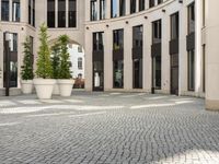 a courtyard in a building with pots on either side of it that are sitting beside each other