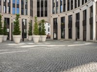 a courtyard in a building with pots on either side of it that are sitting beside each other