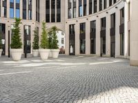 a courtyard in a building with pots on either side of it that are sitting beside each other