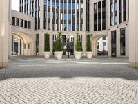 a courtyard in a building with pots on either side of it that are sitting beside each other