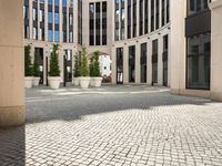 a courtyard in a building with pots on either side of it that are sitting beside each other