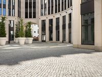 a courtyard in a building with pots on either side of it that are sitting beside each other