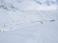 a cross country skier is traveling down a snowy slope in the mountains to ski on