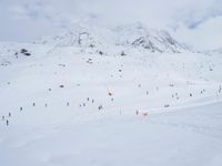 a cross country skier is traveling down a snowy slope in the mountains to ski on