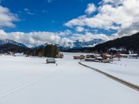 person cross country skiing on snowy terrain with mountains in the background for use as backdrop