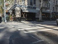 the crosswalk is waiting to cross the street, with several cars driving near by